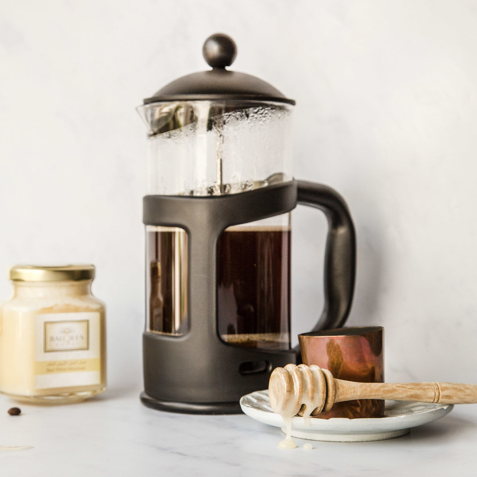 caftiere of coffee with white mountain honey on a drizzler