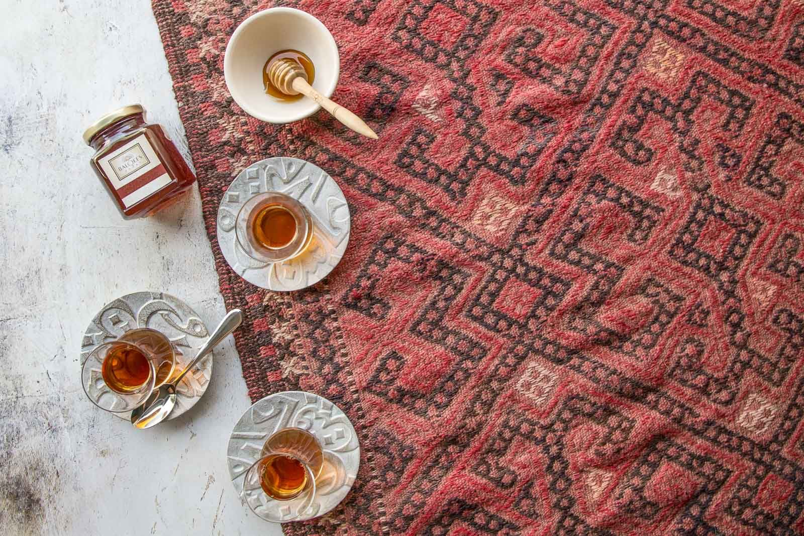 Arabic tea and honey by a carpet