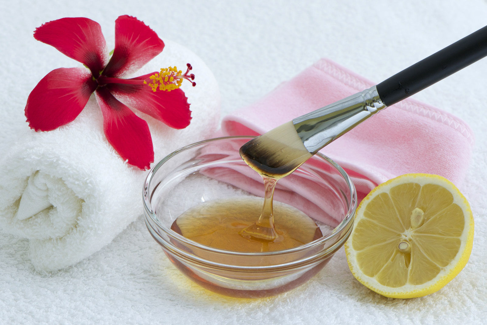 bowl and brush with raw honey and beauty items